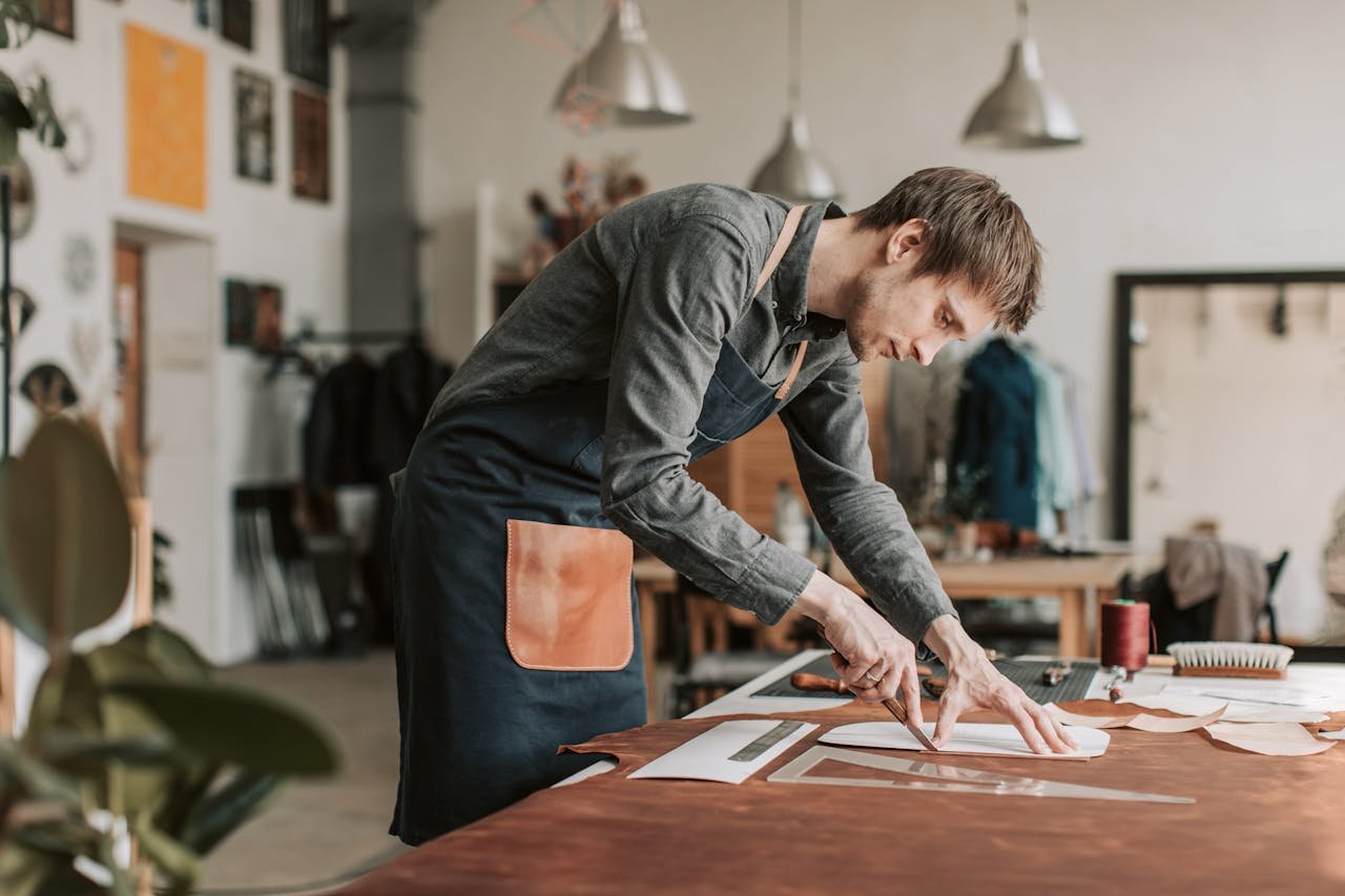 The Art of Drawing Readers In: Your attractive post title goes here Skilled artisan at work cutting leather in a creative workshop setting.